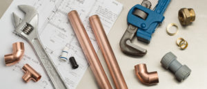 various plumbing tools on top of a blue print