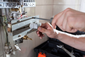Close-up of a gas water heater repair