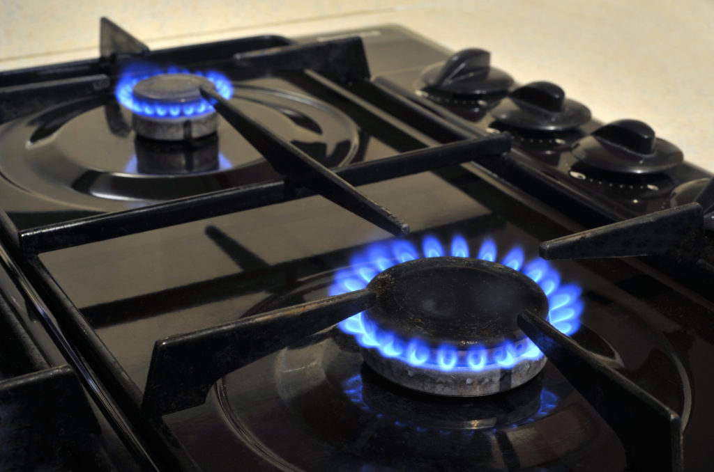 Gas burner rings on a kitchen oven hob.