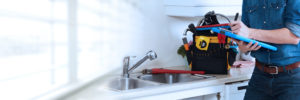 Professional plumber working renovation in kitchen home.